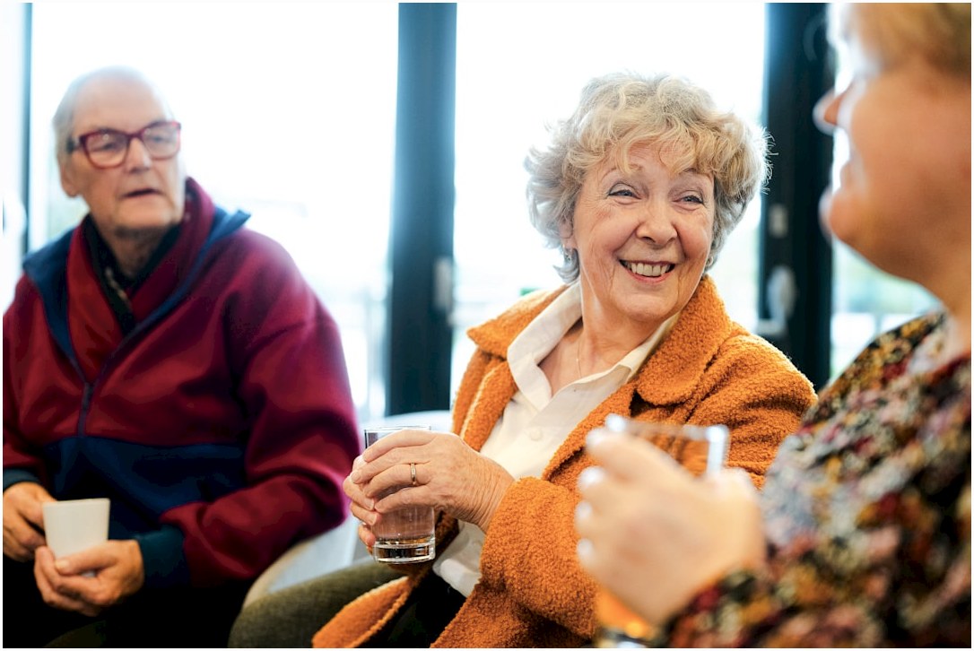 Three seniors talking and smiling together