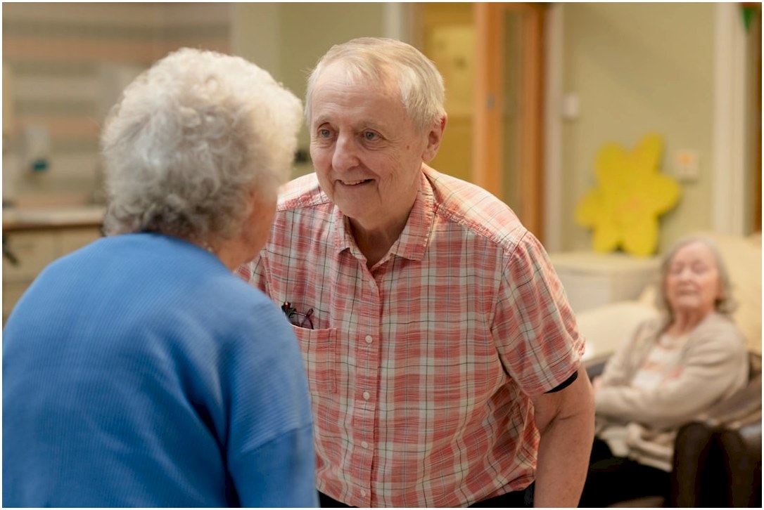 Elderly couple talking in a room