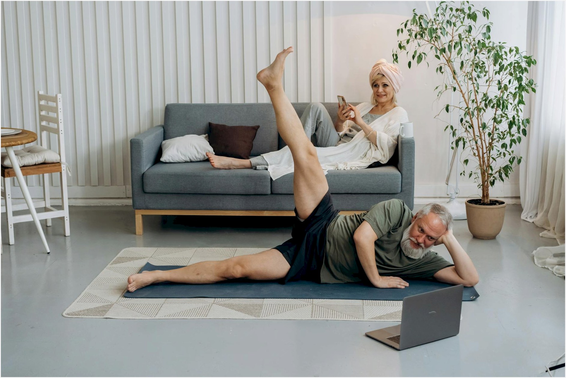 Seniors practicing yoga exercises at home for a healthy lifestyle.