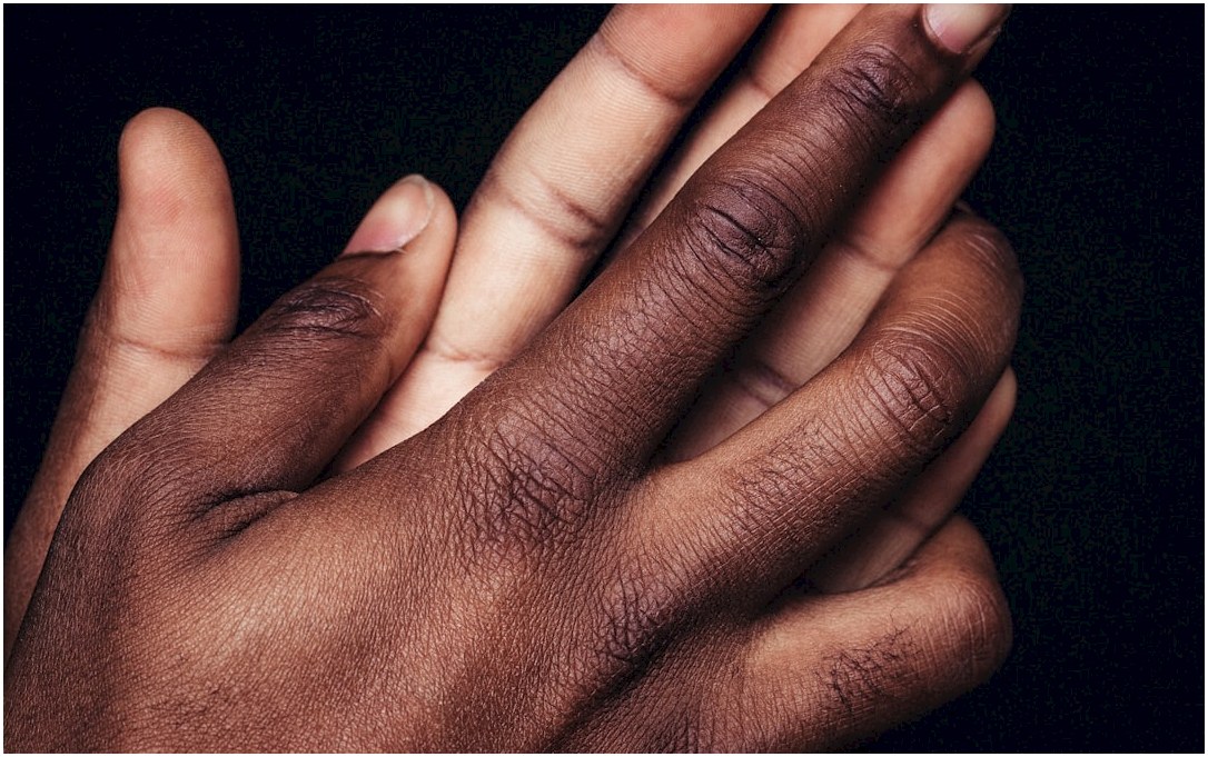 persons left hand on black textile
