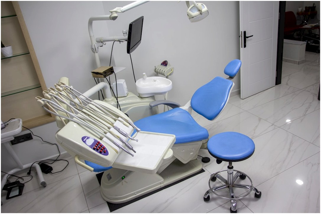 a dental room with a blue chair and dental equipment