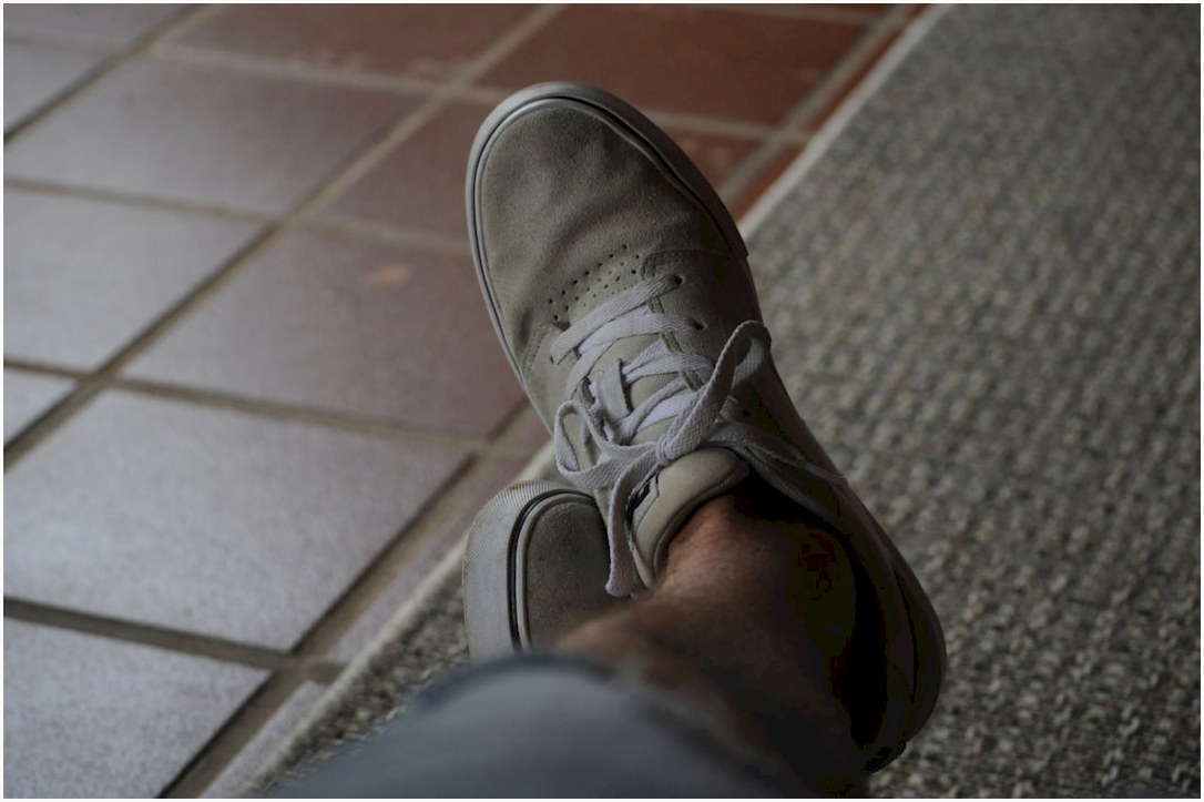 person wearing gray nike sneaker