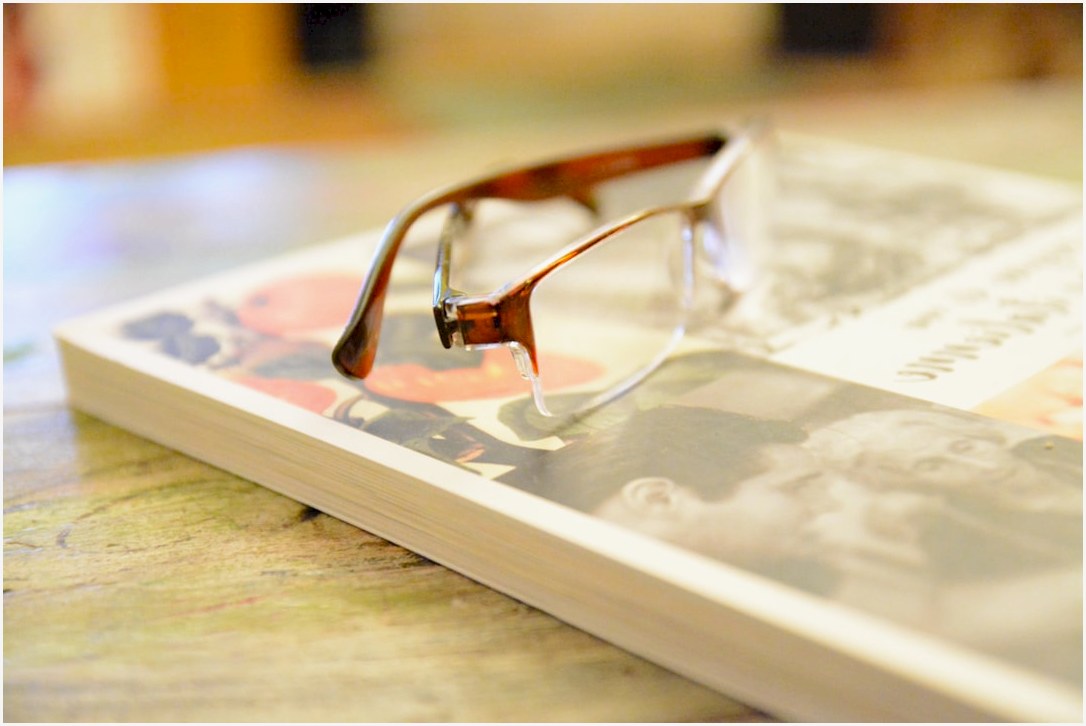 brown framed eyeglasses on brown wooden table