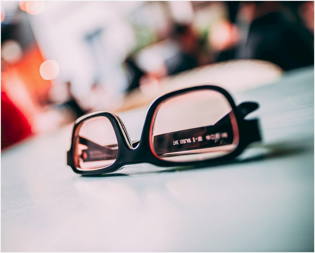 black framed eyeglasses on white table