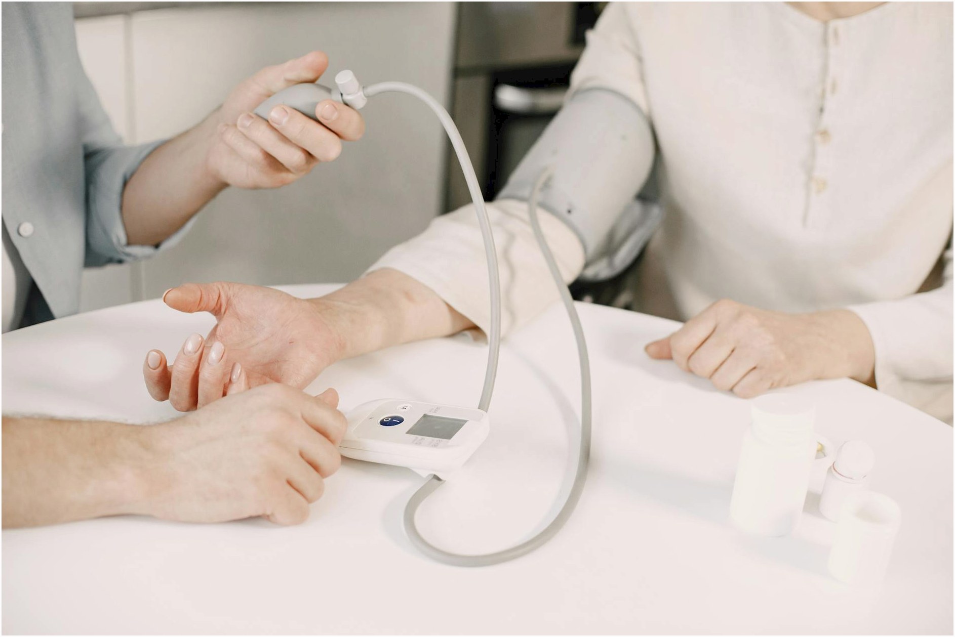 Close-up of blood pressure measurement at home highlighting healthcare equipment.