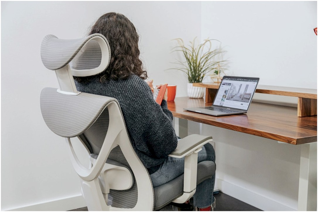 a woman sitting at a desk with a laptop