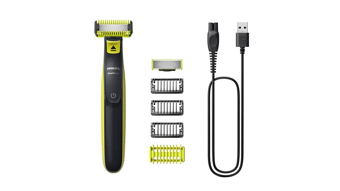 Barbeador e aparador Philips OneBlade QP2824/10 com pentes, protetor e cabo USB sobre fundo branco.